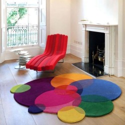 Tapis salon devant la cheminée design contemporain couleurs vives composition des cercles multicolores.