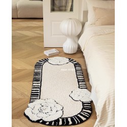 Tapis fleur élégante pour chambre, descente de lit format ovale allongé.