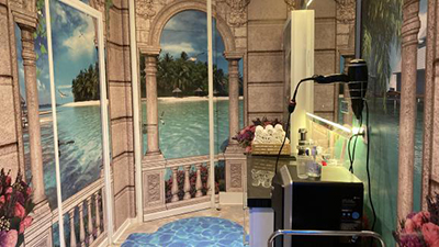 Installation des papiers peints sur mesure Atelier WYBO dans un centre de bien-être et SPA dans la région parisienne, un paysage panorama 360 degrès dans le coulour, mer tropicale île verte plantes et fleurs exotiques.